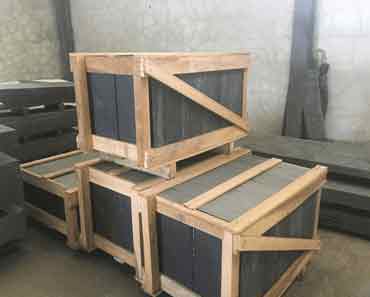 Stacks of Porto VALONGO BLACK™ slate slabs stored in warehouse ready